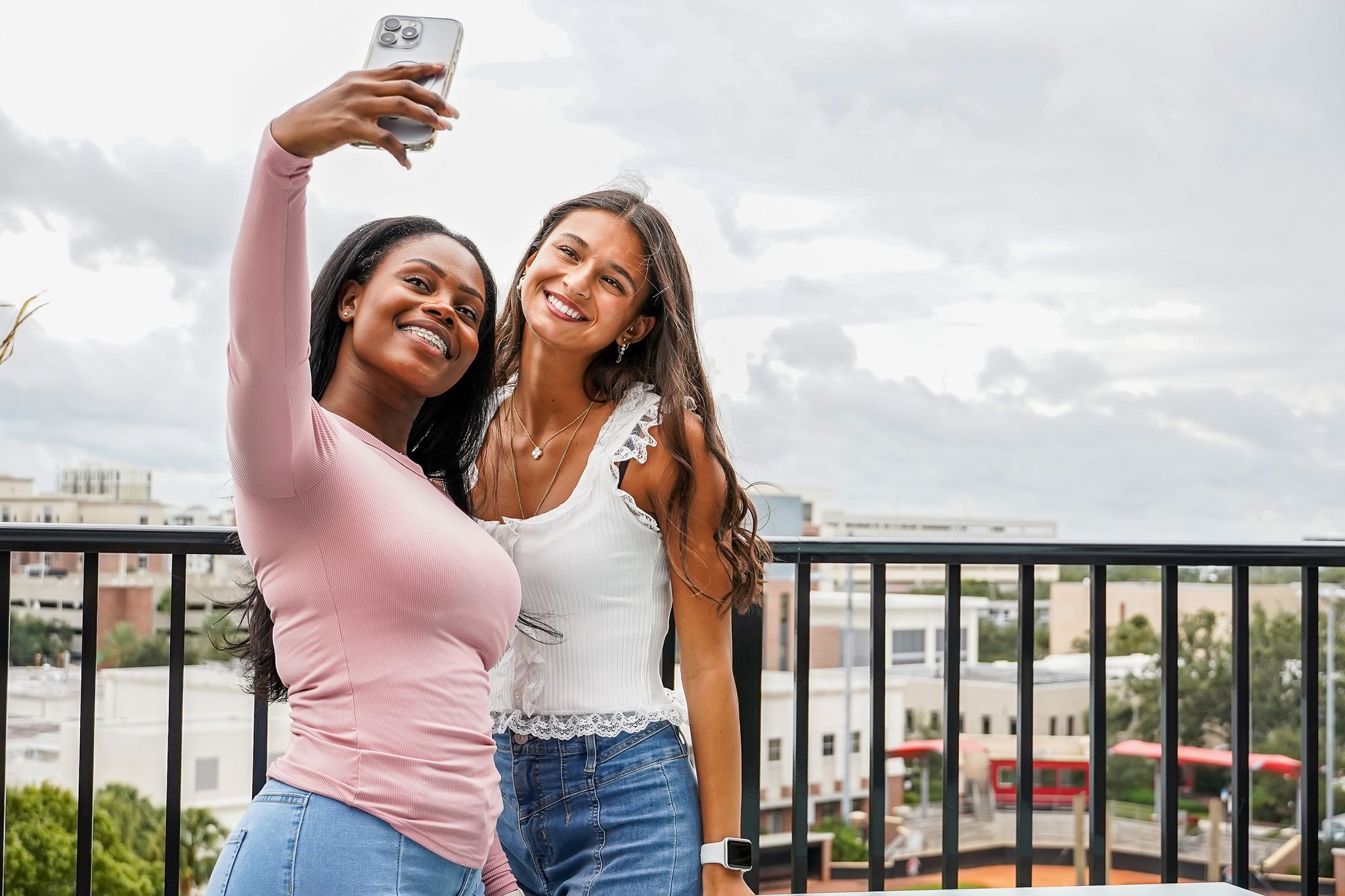 Two women taking a selfie outdoors.