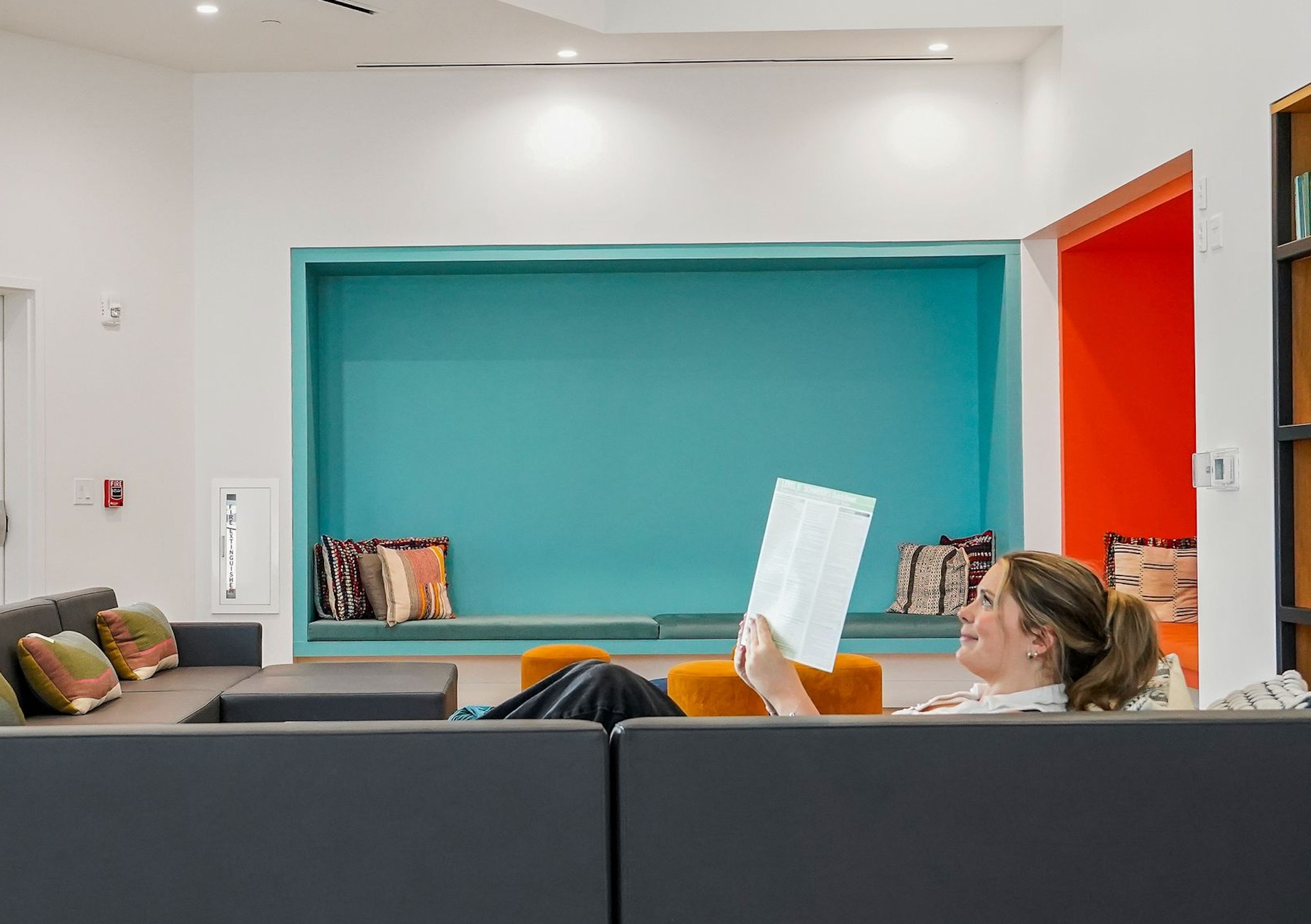 Resident reading in the lounge at Apella On Newport